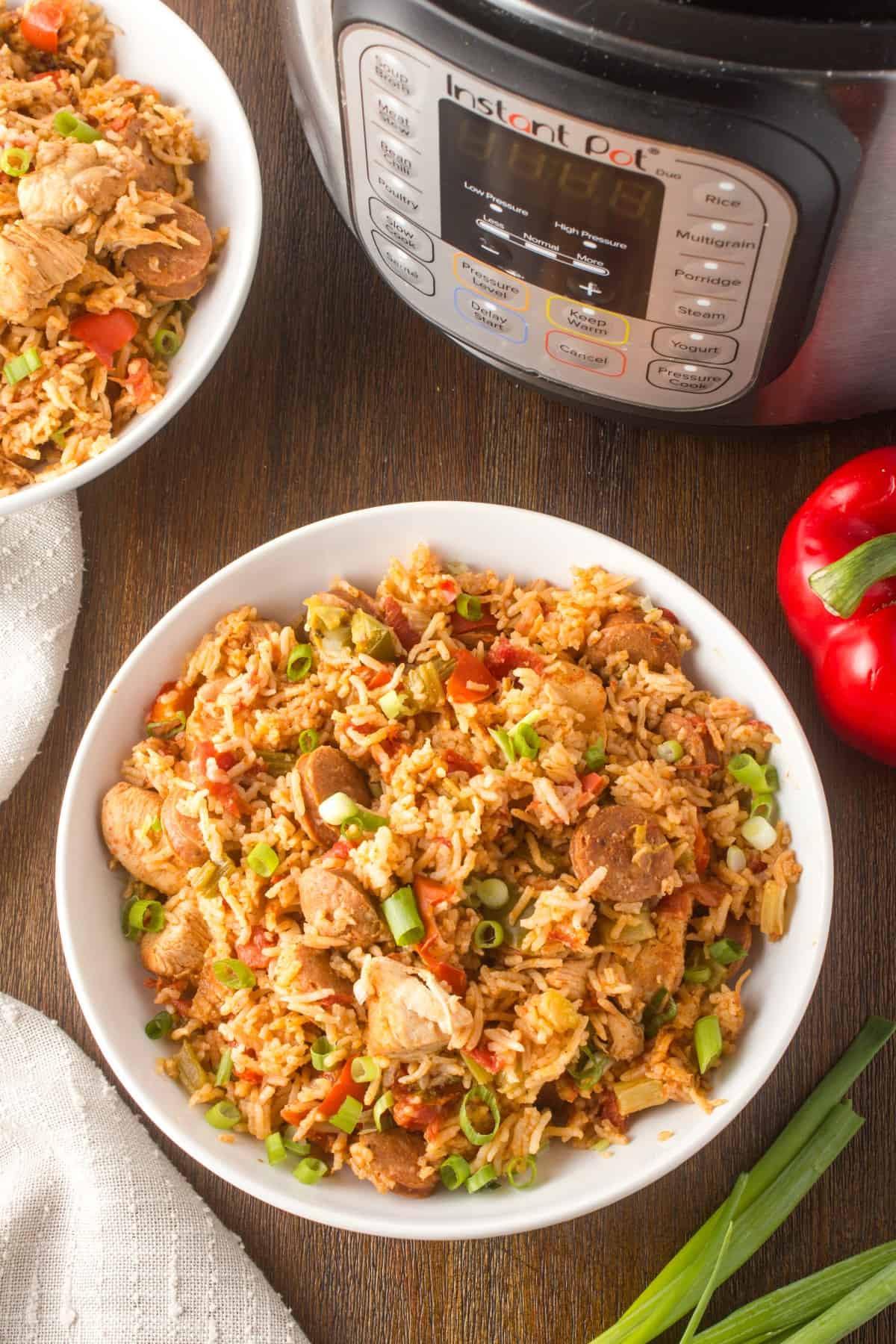 Bowls of jambalaya and showing the Instant Pot also. 