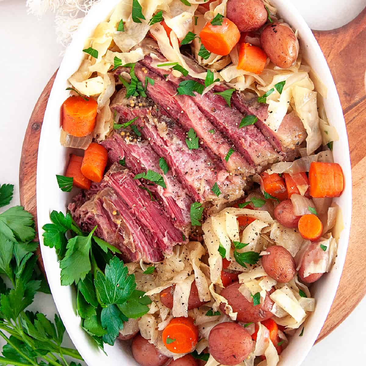 Square photo of corned beef dinner in a casserole with parsley. 