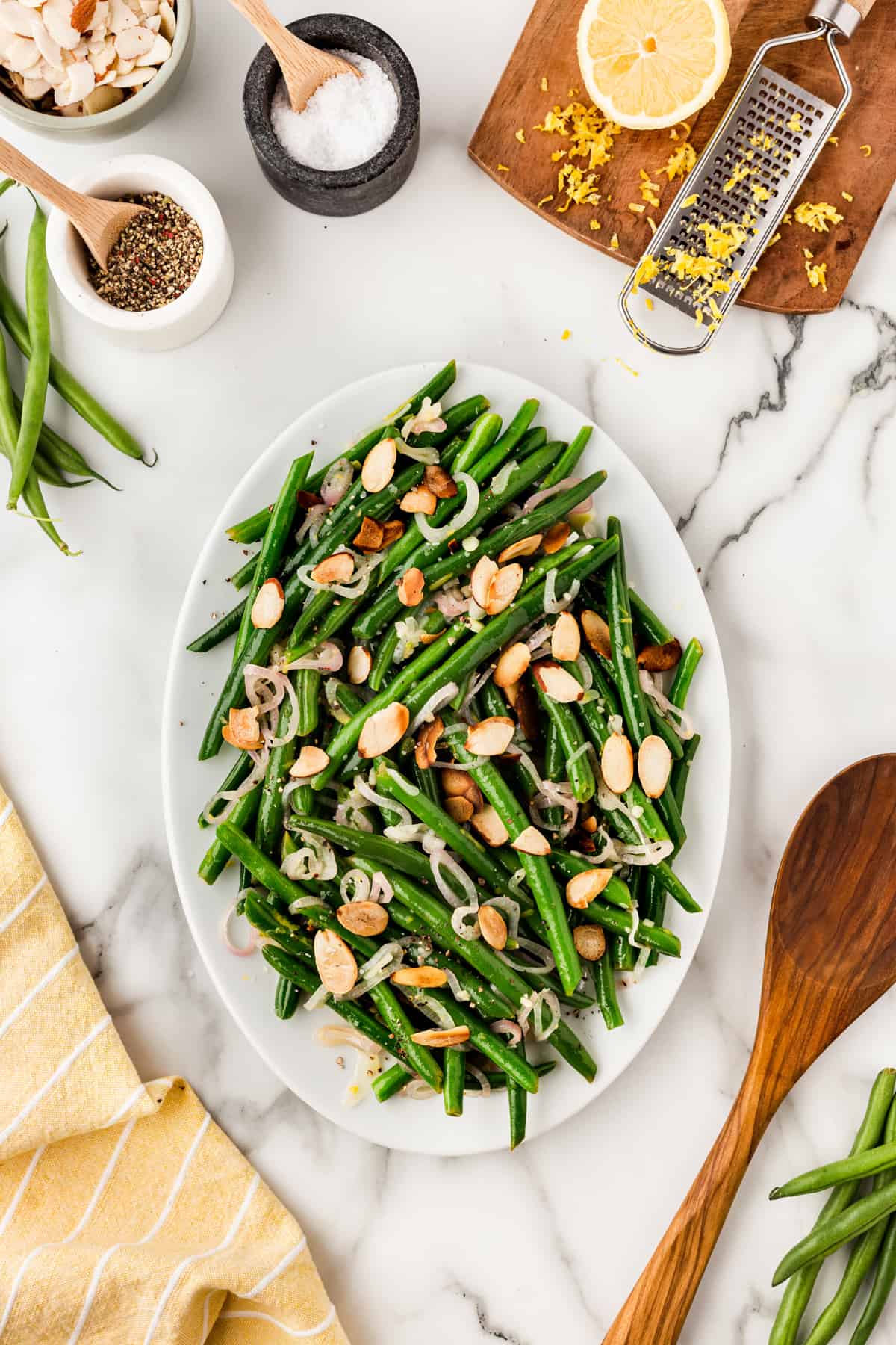 Overhead of green beans almondine on a platter. 