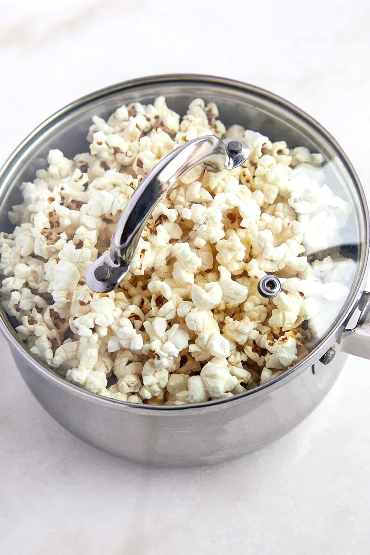 Popcorn in a pot with the lid on. 