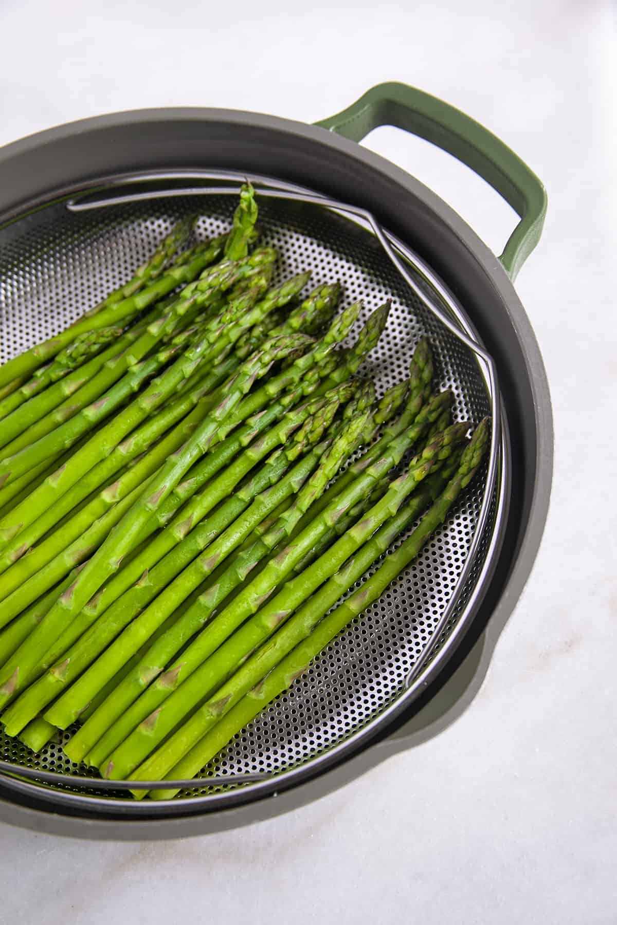 Asparagus in a steamer basket. 