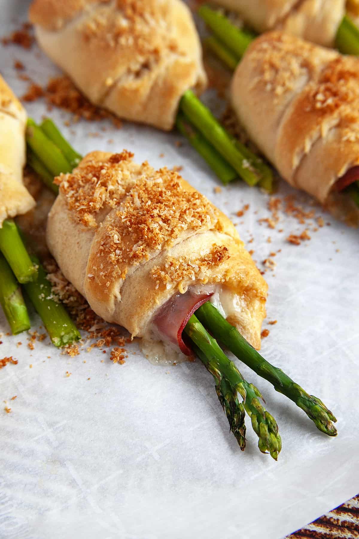 Close-up of a crescent roll topped with panko cheese crumbs. 
