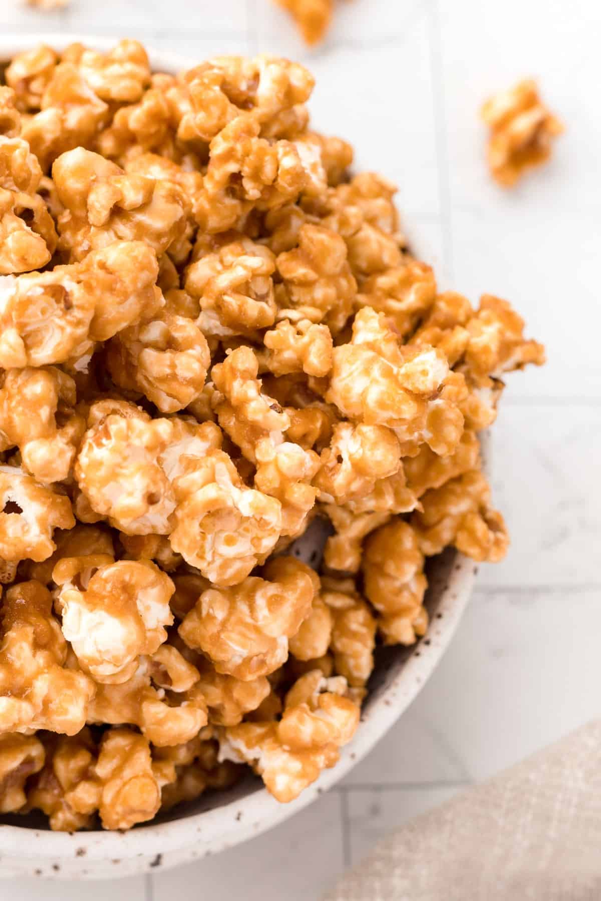 Close-up overhead of caramel corn in a dish. 