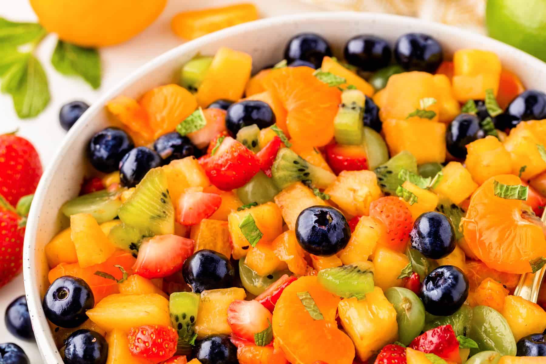 Close-up view of fruit salad in a bowl, horizontal. 