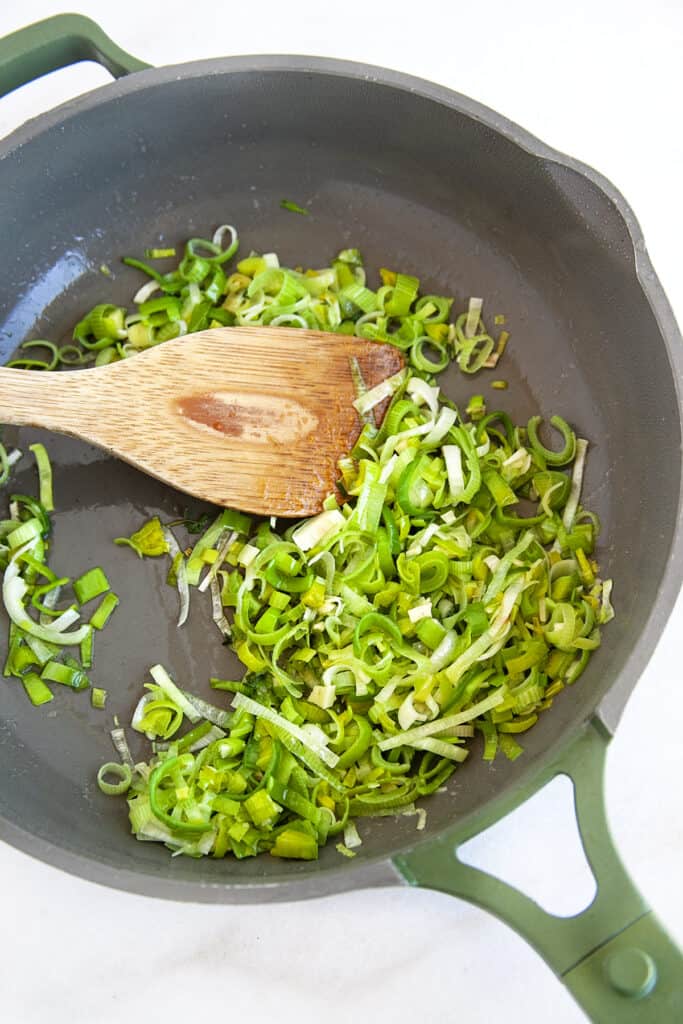 Sauteing leeks in a fry pan. 