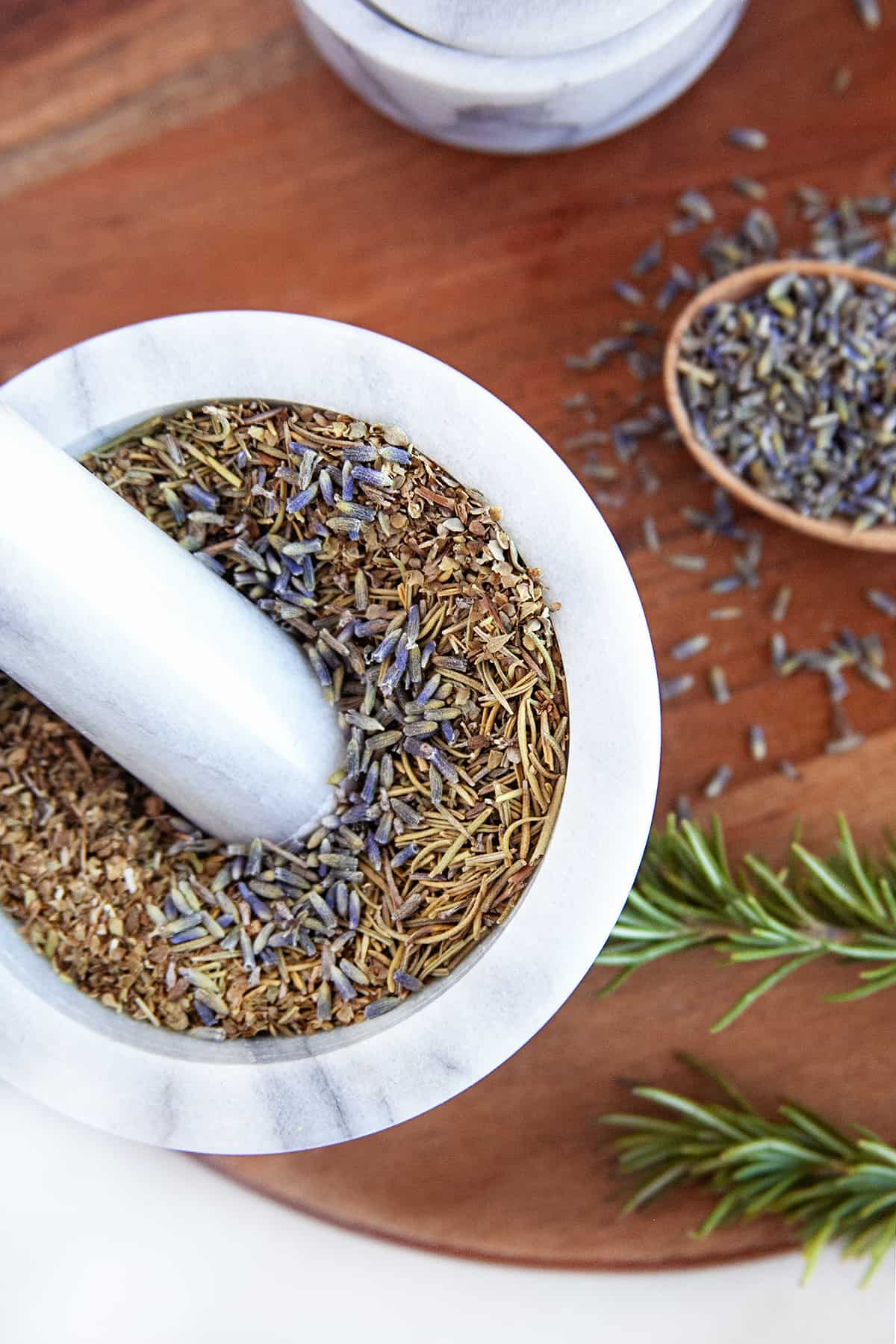 Showing lavender in Herbs de Provence in a mortar and pestle. 