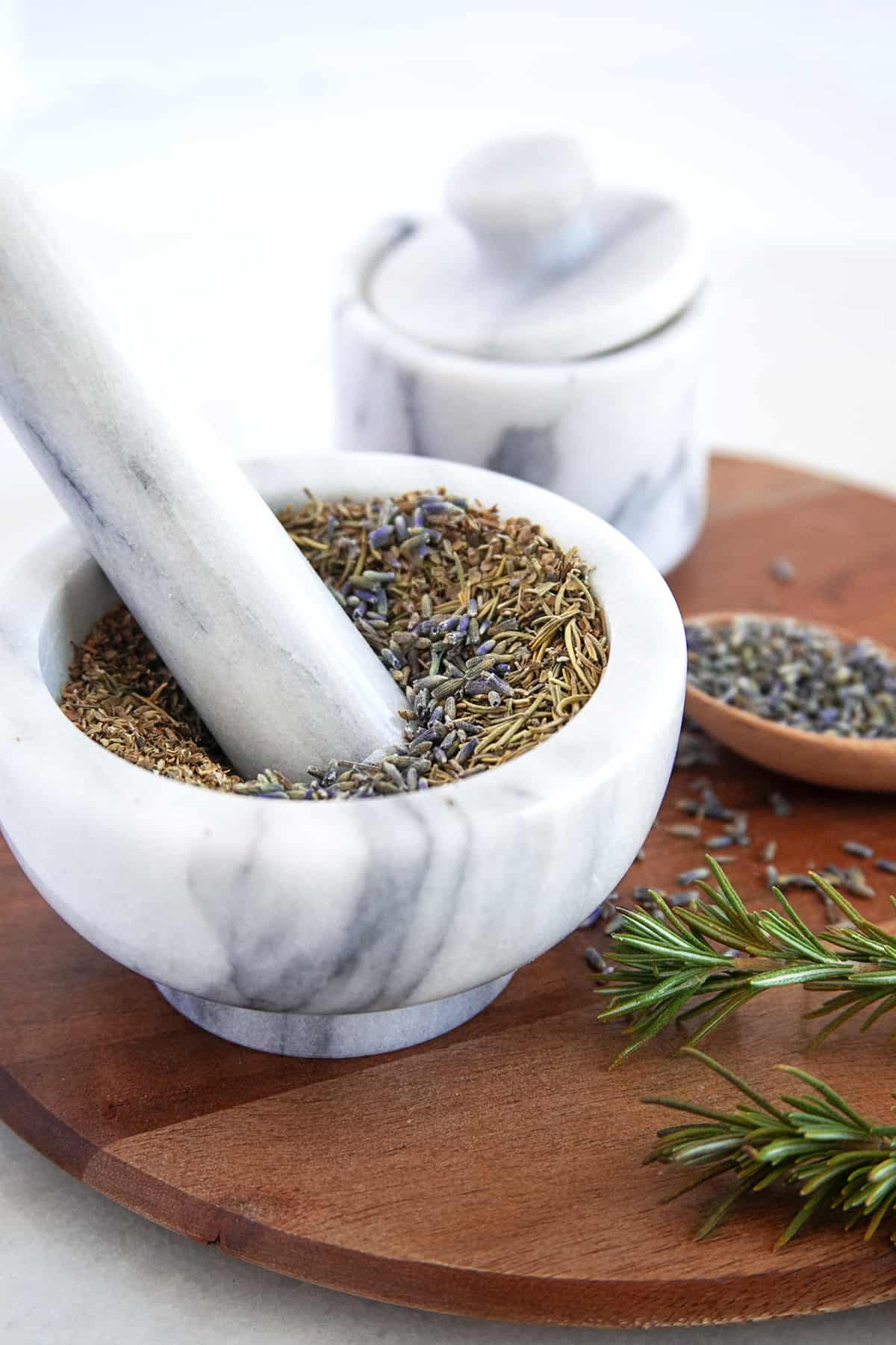 Mixing in lavender into Herbs de Provence in a mortar and pestle. 