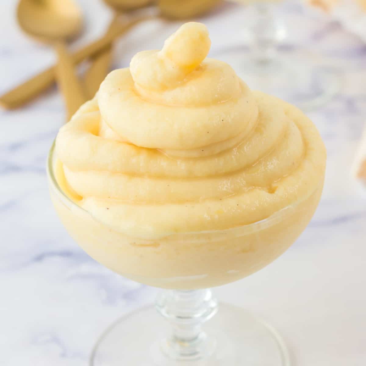 Square photo of Pineapple Dole Whip in a small wide glass. 