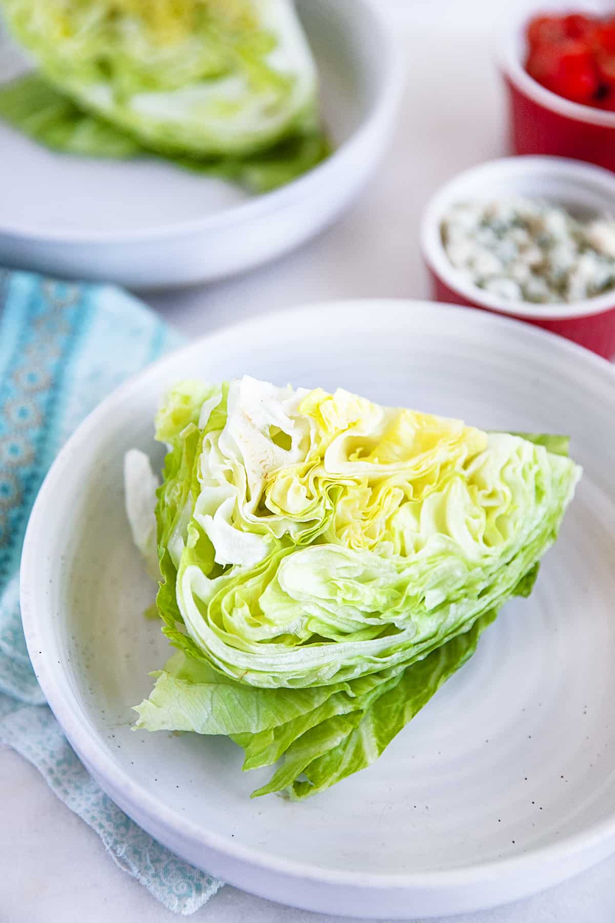 Wedge of lettuce on a white plate. 