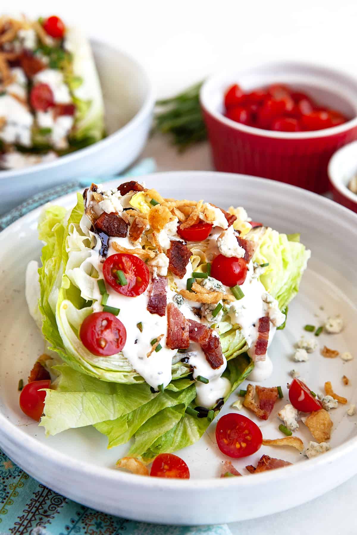 Front view shot of a wedge salad on a white plate. 