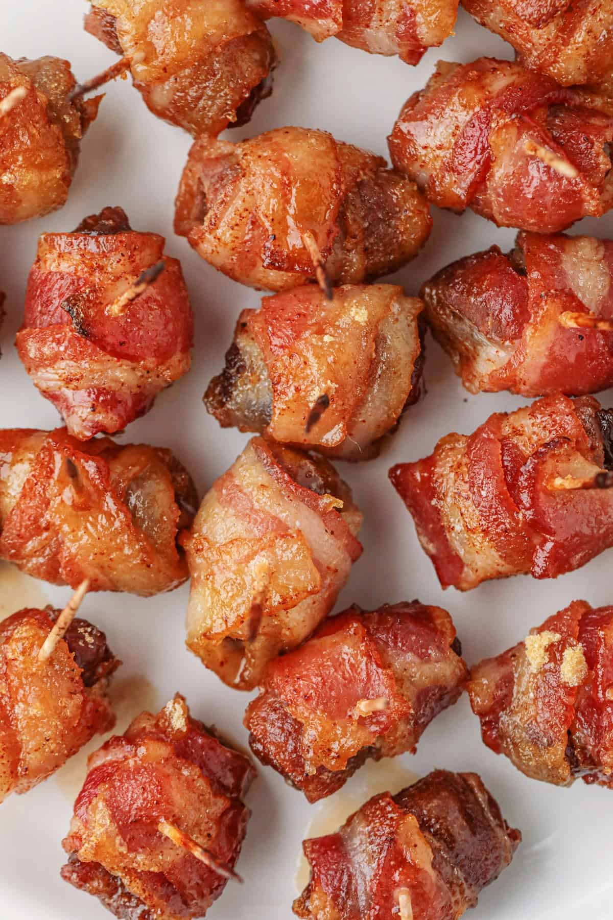 Overhead close-up of bacon-wrapped dates. 