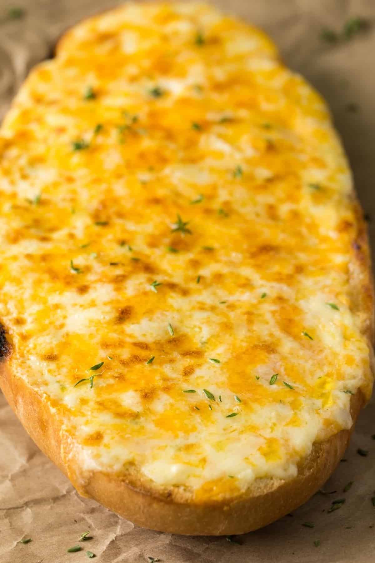 Uncut loaf of cheese garlic bread. 