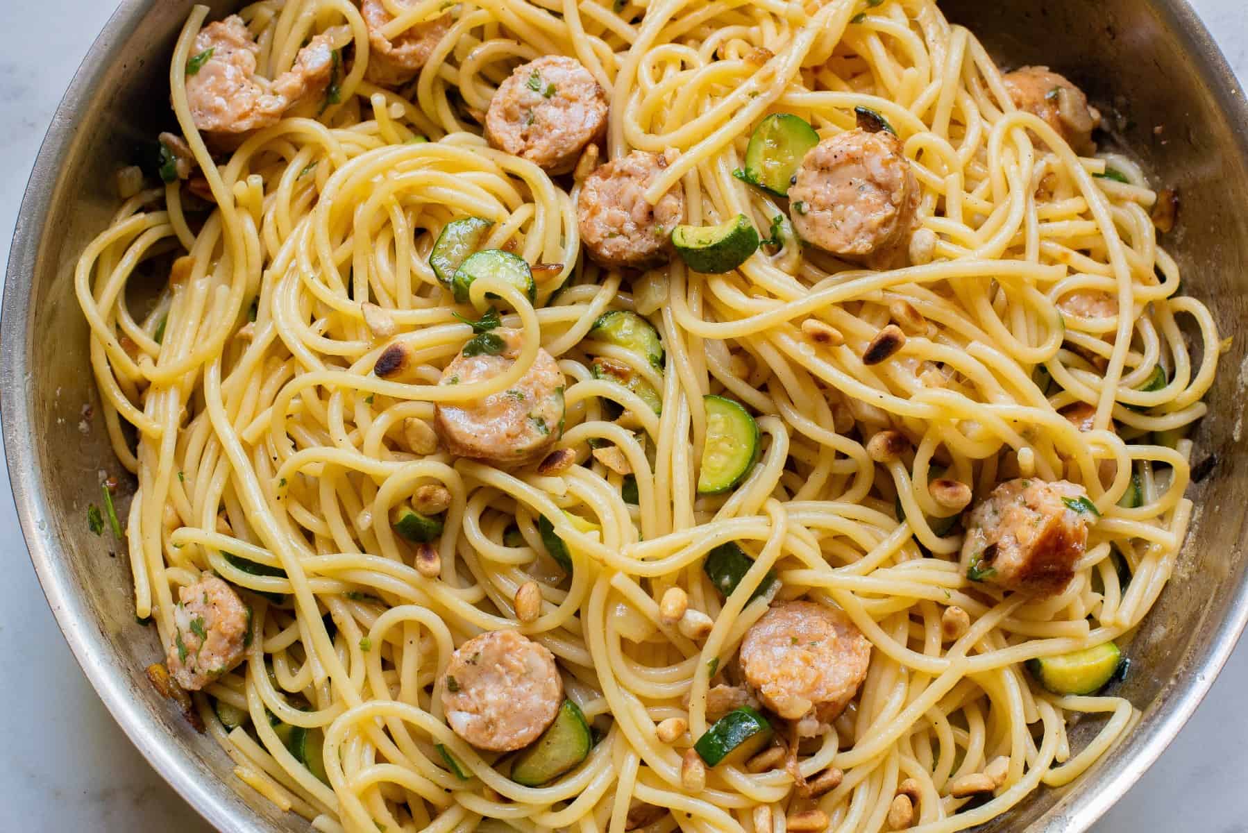 Horizontal picture of spaghetti with chicken sausage and zucchini. 