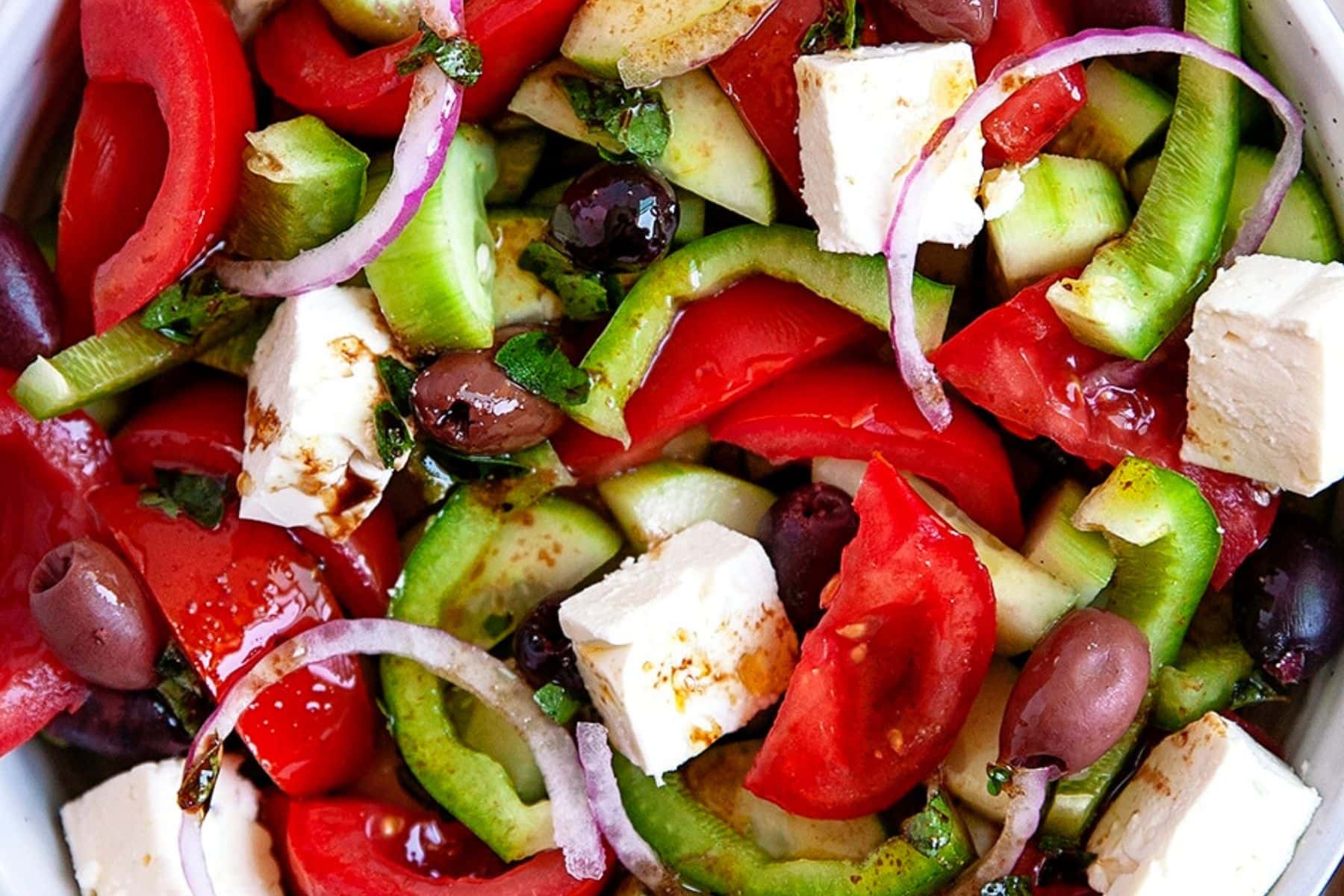 This Classic Greek Salad is simple to make and bursting with delicious fresh flavors. A true classic salad that is enjoyed year-round. Close up of salad.