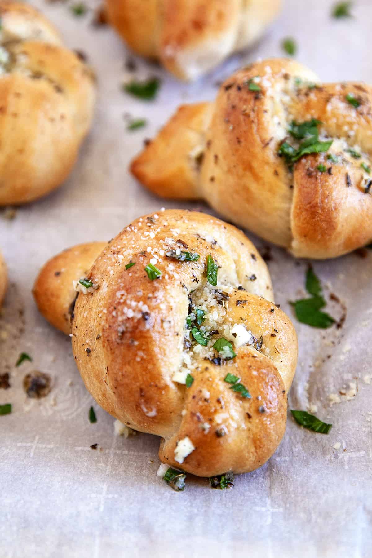 Close-up of garlic knots on parchment. 