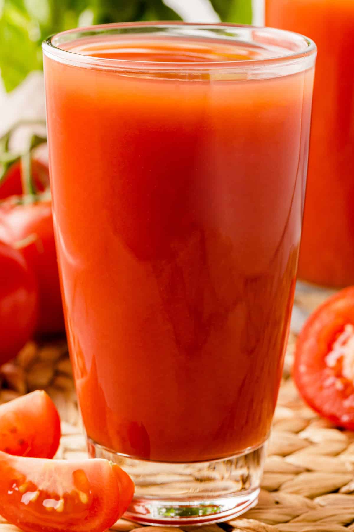 Full glass of tomato juice close up. 