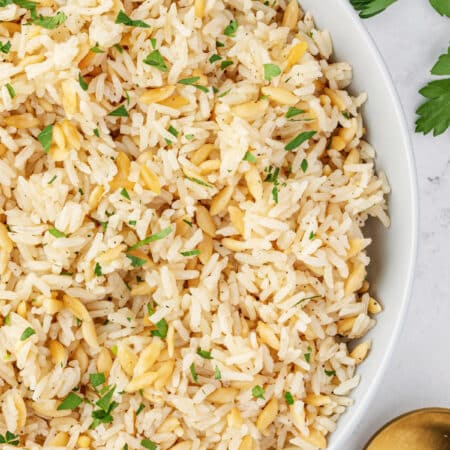 Showing a half section of a large bowl of rice pilaf from overhead.