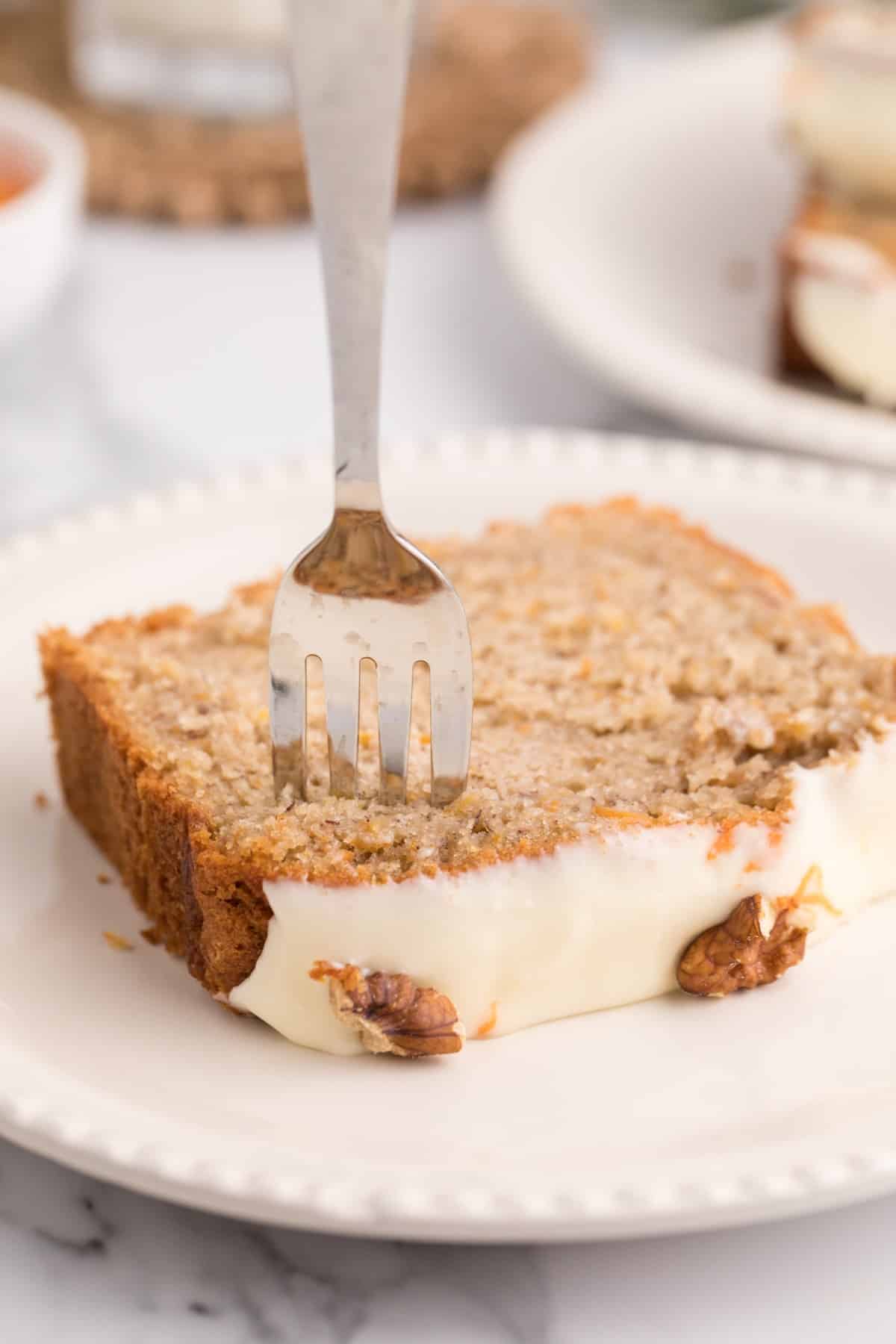 Sticking a fork into a slice of banana bread. 