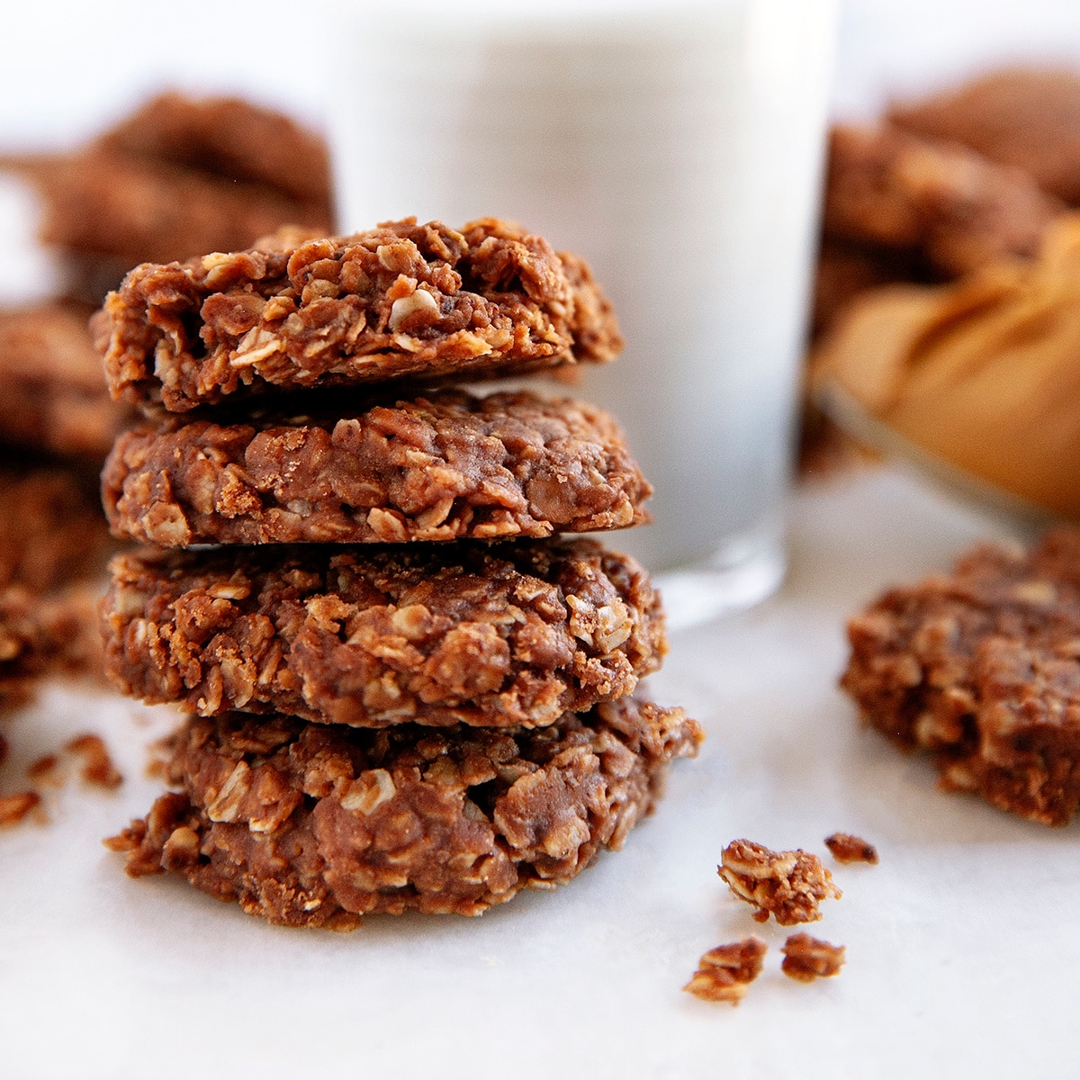 4 stacked cookies and a glass of milk.