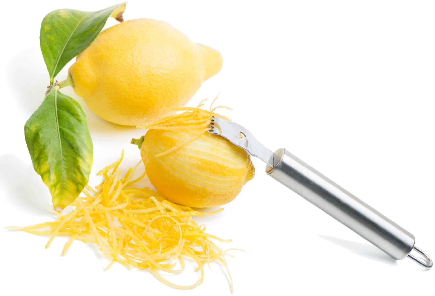 Lemon with leaves, lemon zest with zester isolated on a white background.
