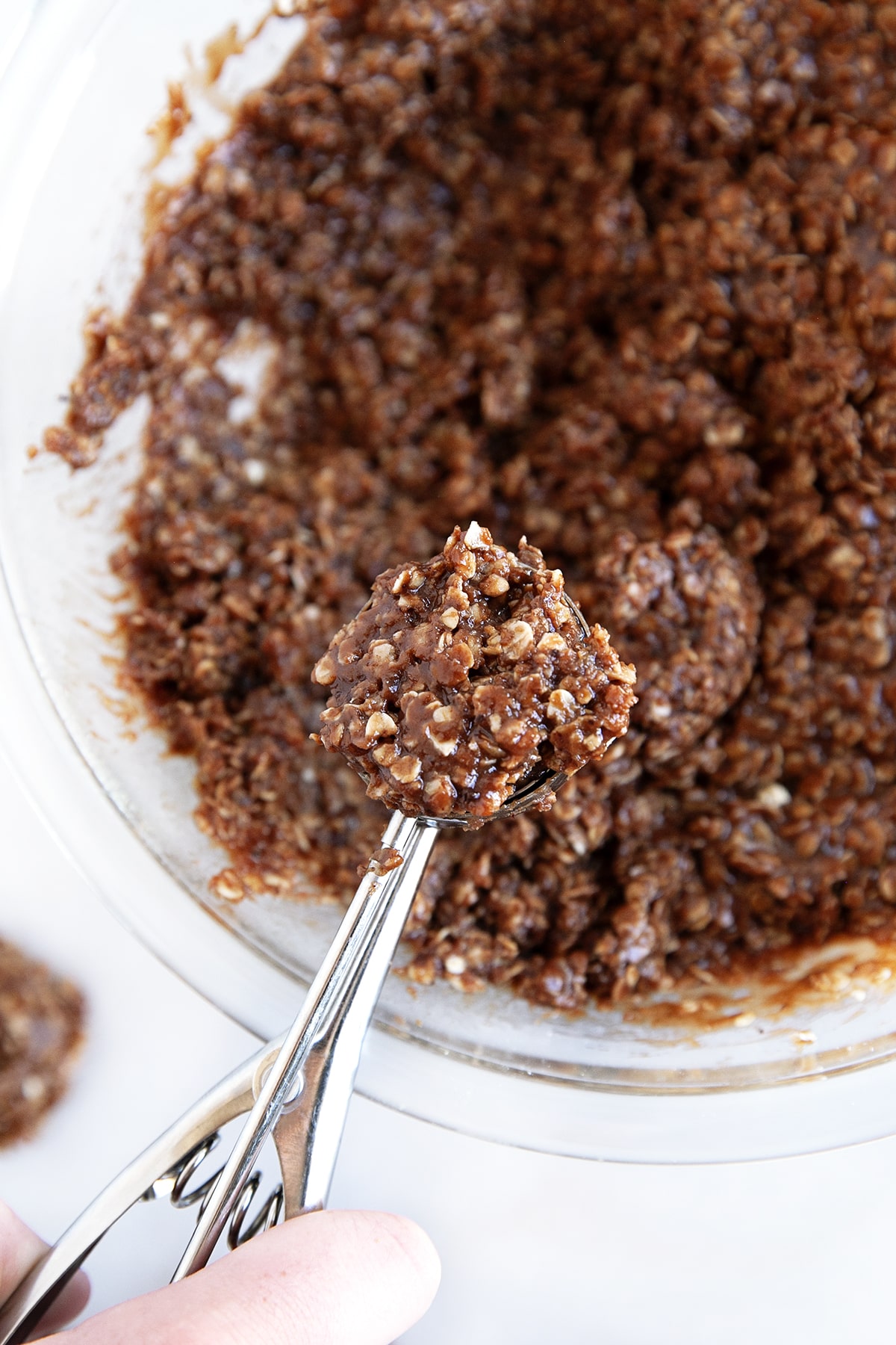 Scooping out cookie dough with a cookie scoop. 