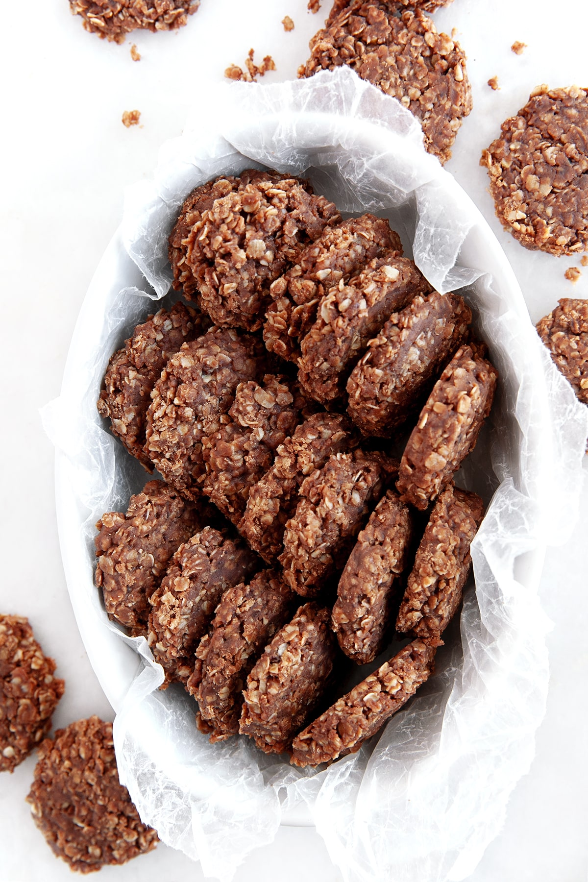 Overhead shot of no-bake cookies in a oval dish with wax paper. 