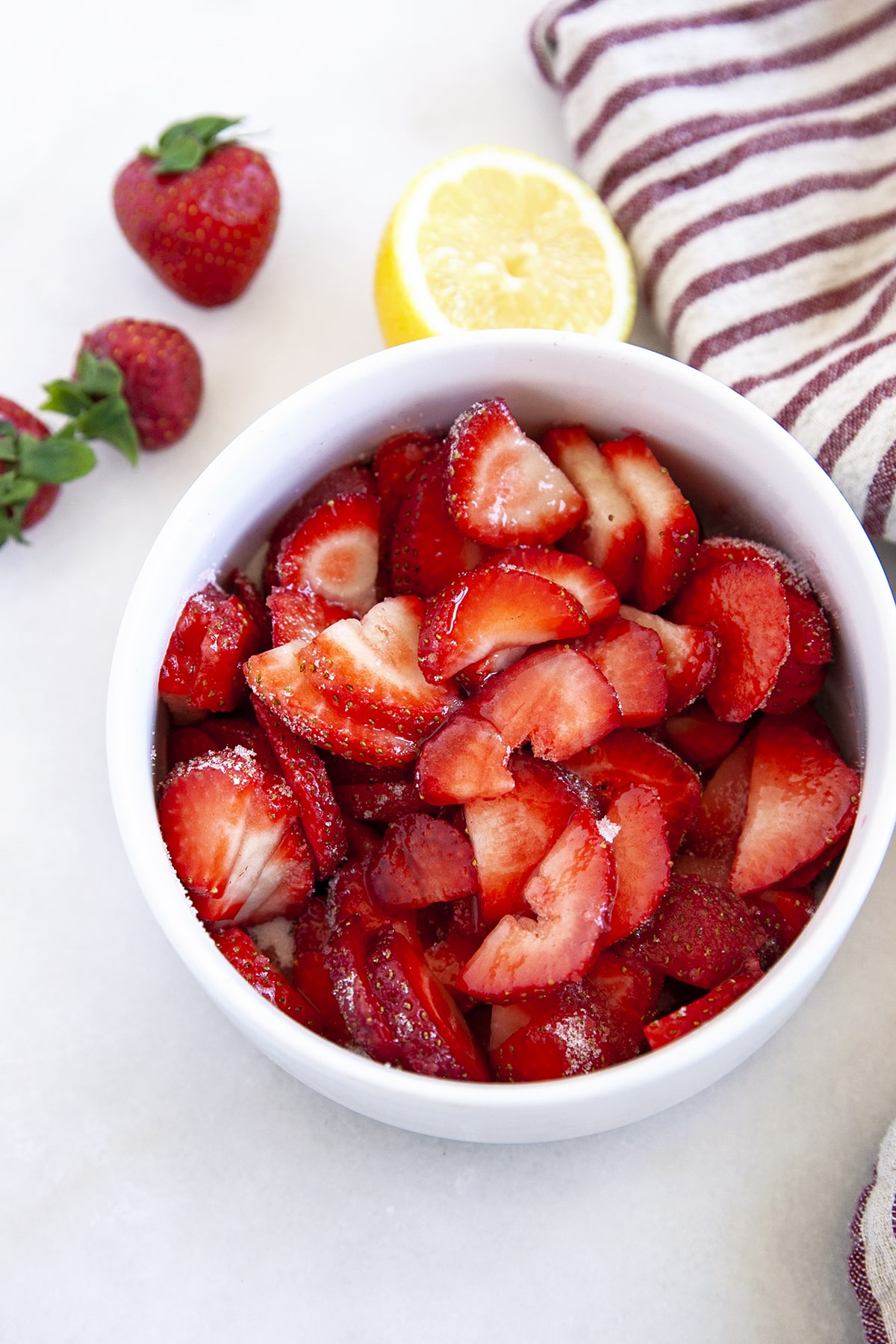 Strawberries and sugar in a bowl. 