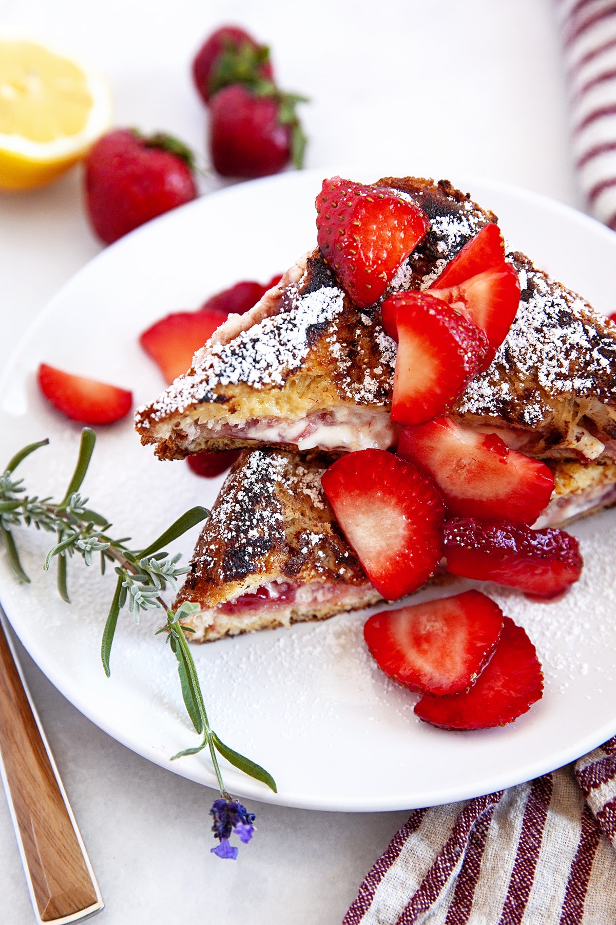 Stuffed French Toast with strawberries on a white plate. 