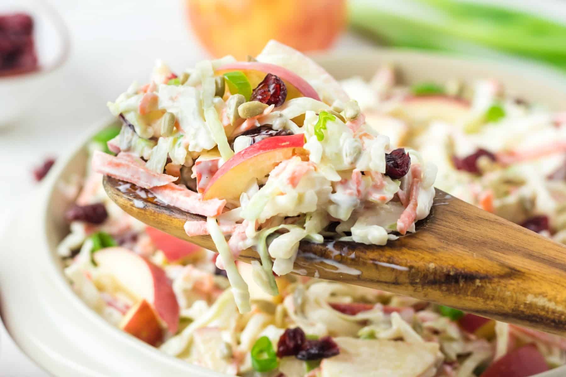 Horizontal picture of coleslaw on a wooden spoon. 