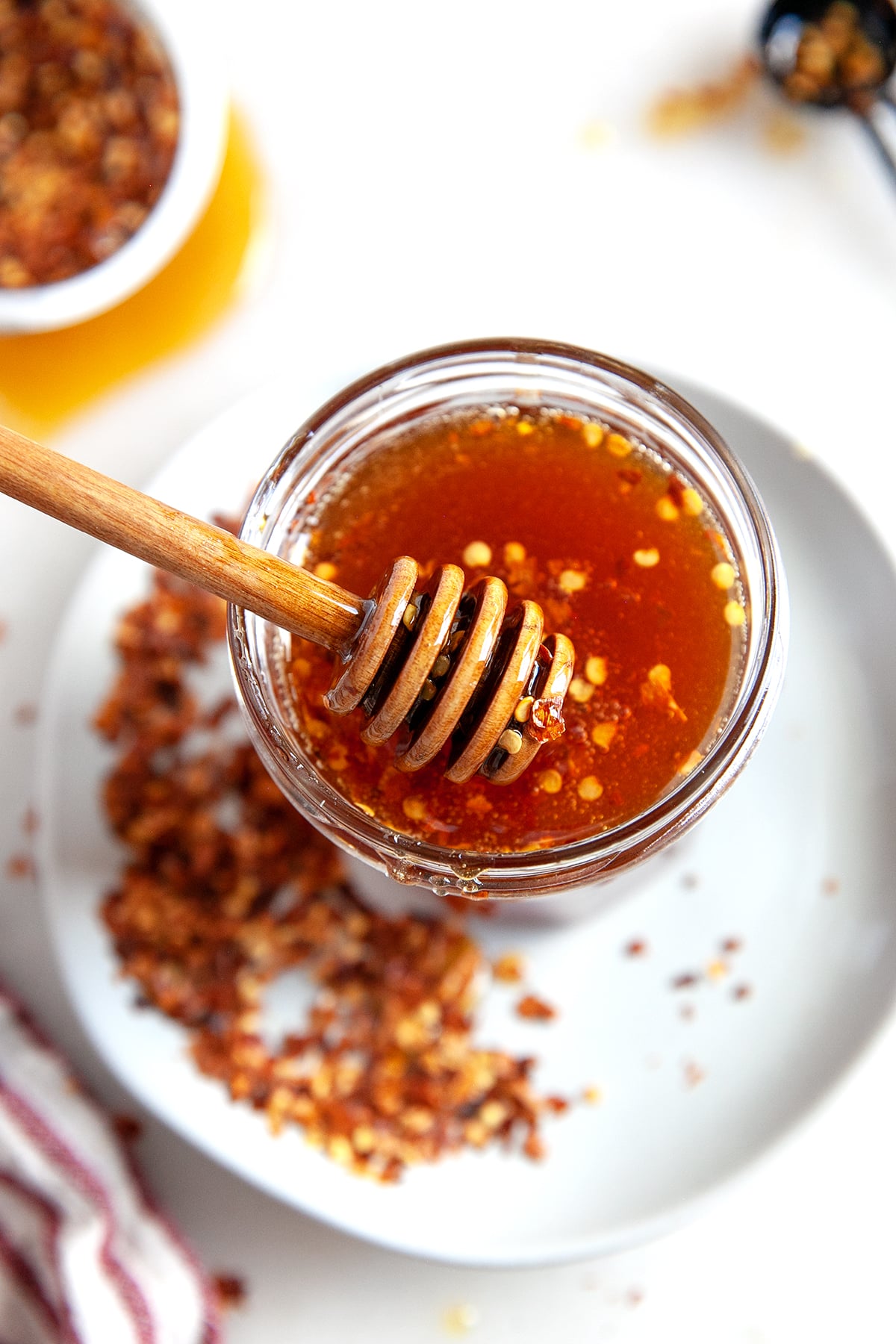 Overhead shot of hot honey in a jar with a dipper. 