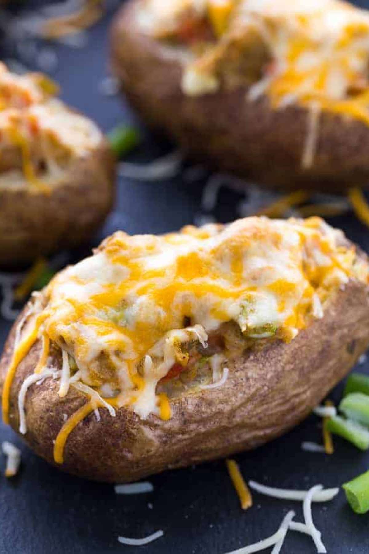 Twice baked pepper stuffed potatoes  covered with melted cheese.