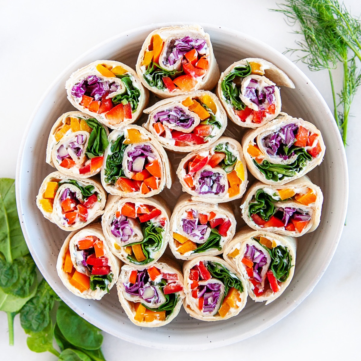 Overhead shot of pinwheels in a round dish. 