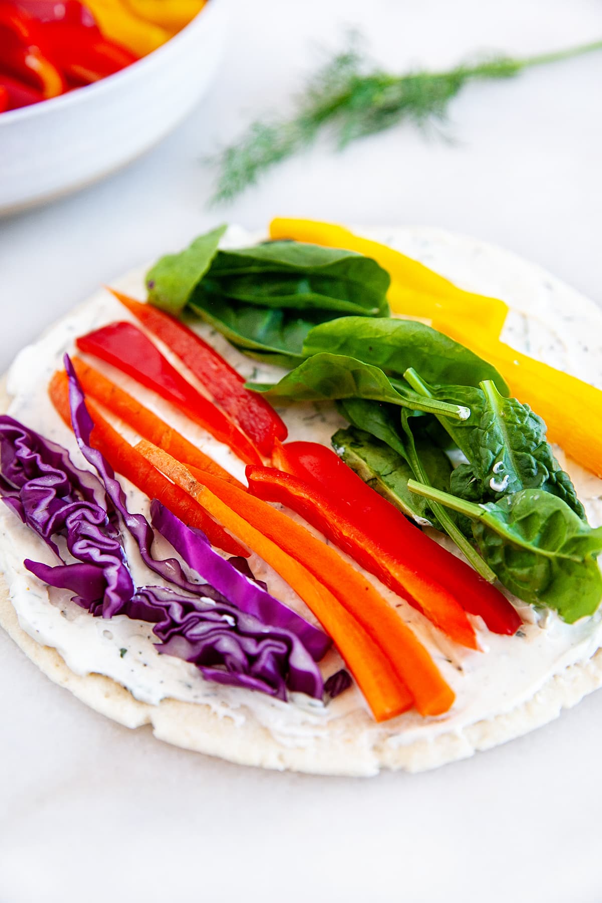 Close-up showing vegetables on a tortilla. 