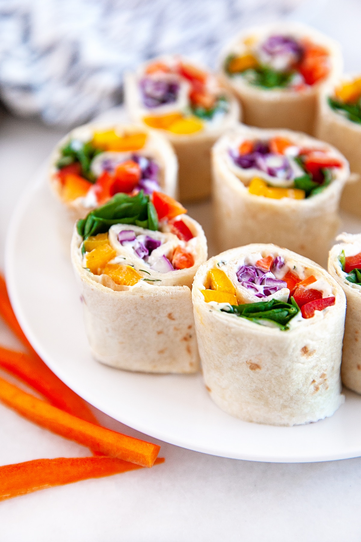 Front view of vegetable pinwheels in a dish. 