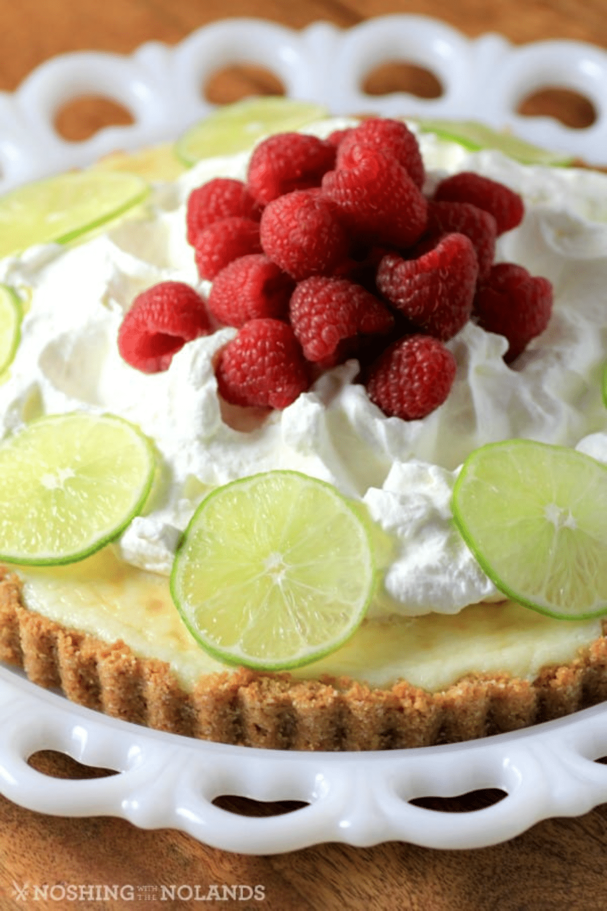 Key Lime Tart with fresh raspberries, whipped cream and lime slices. 