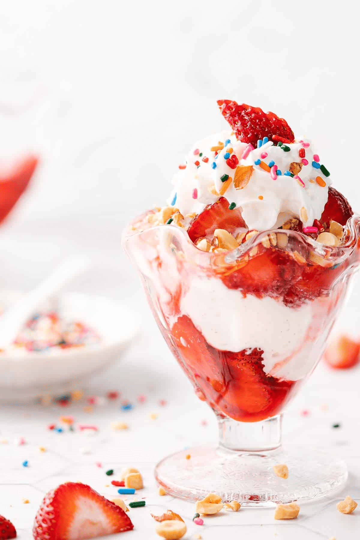 Classic strawberry sundae in an ice cream dish. 