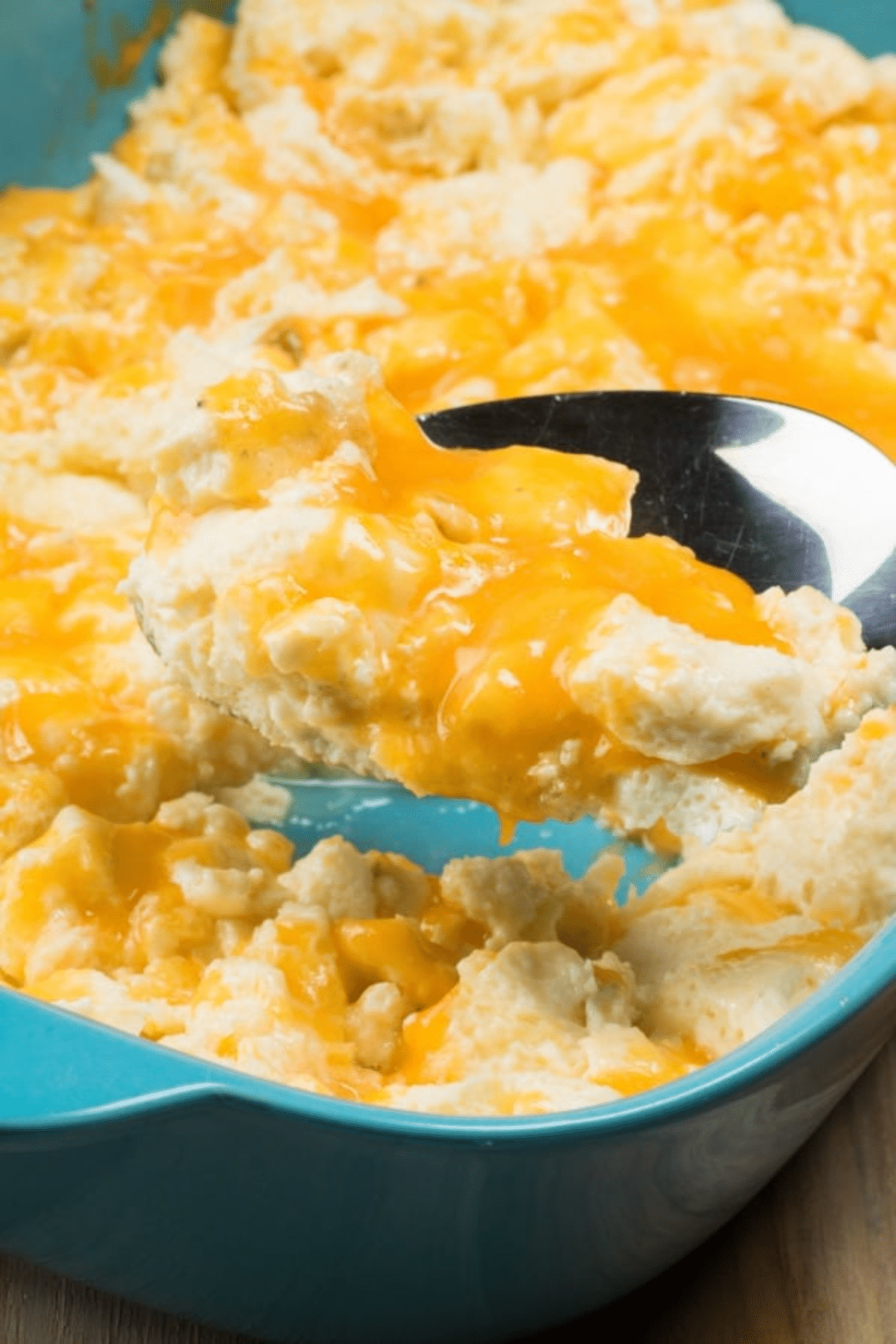 Taking a spoonful of cheesy baked eggs. 