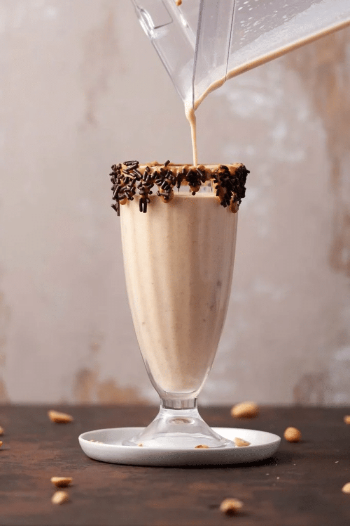 Pouring a 3-Ingredients Peanut Butter Milkshake into a glass. 