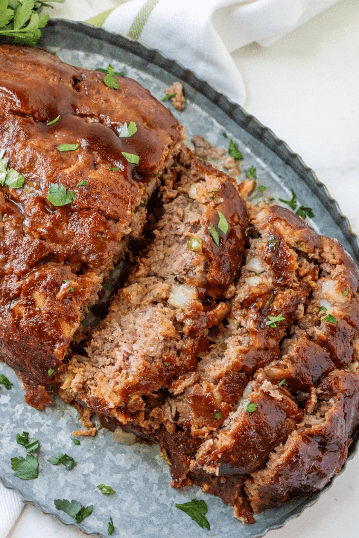Smoked meatloaf sliced on a tray. 