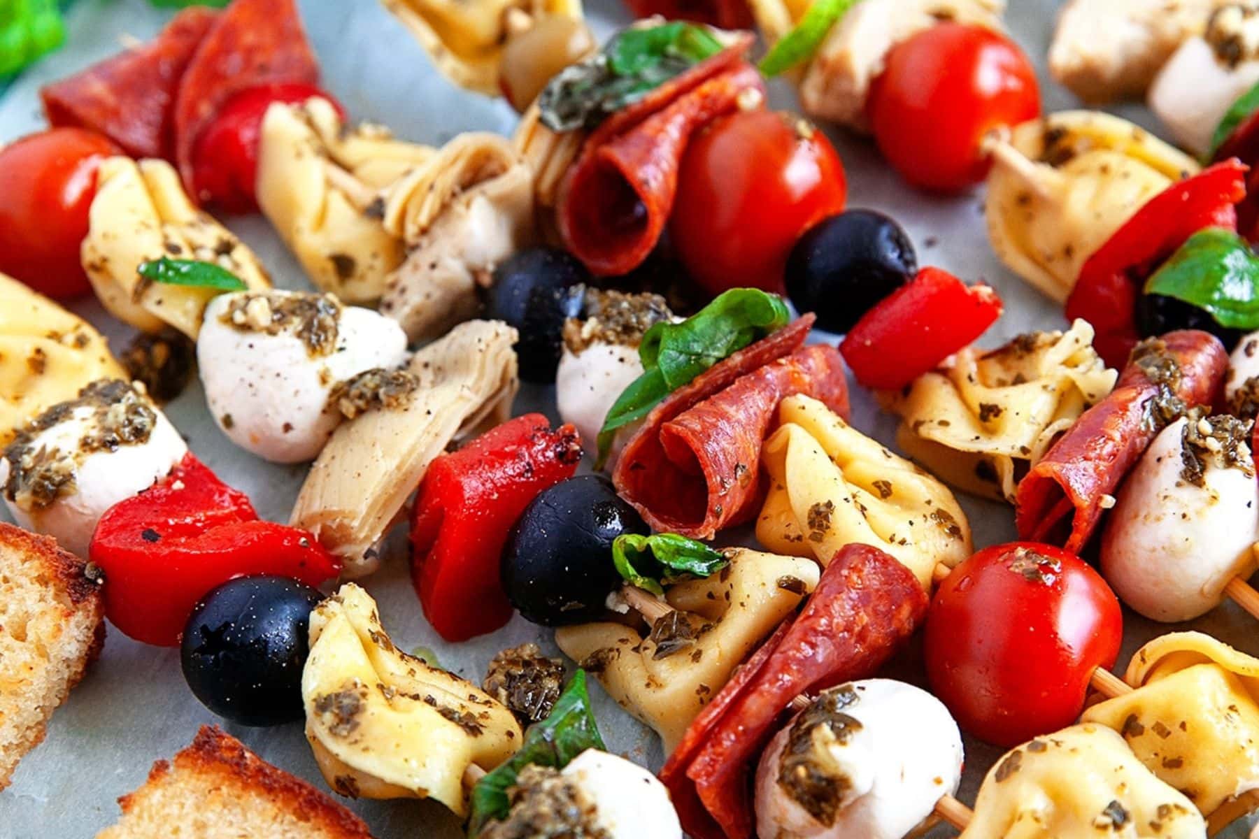 These Appetizer Tortellini Skewers are the perfect way to serve antipasto at a party. They are great in the summer as they are for the holidays. Close up of skewers.