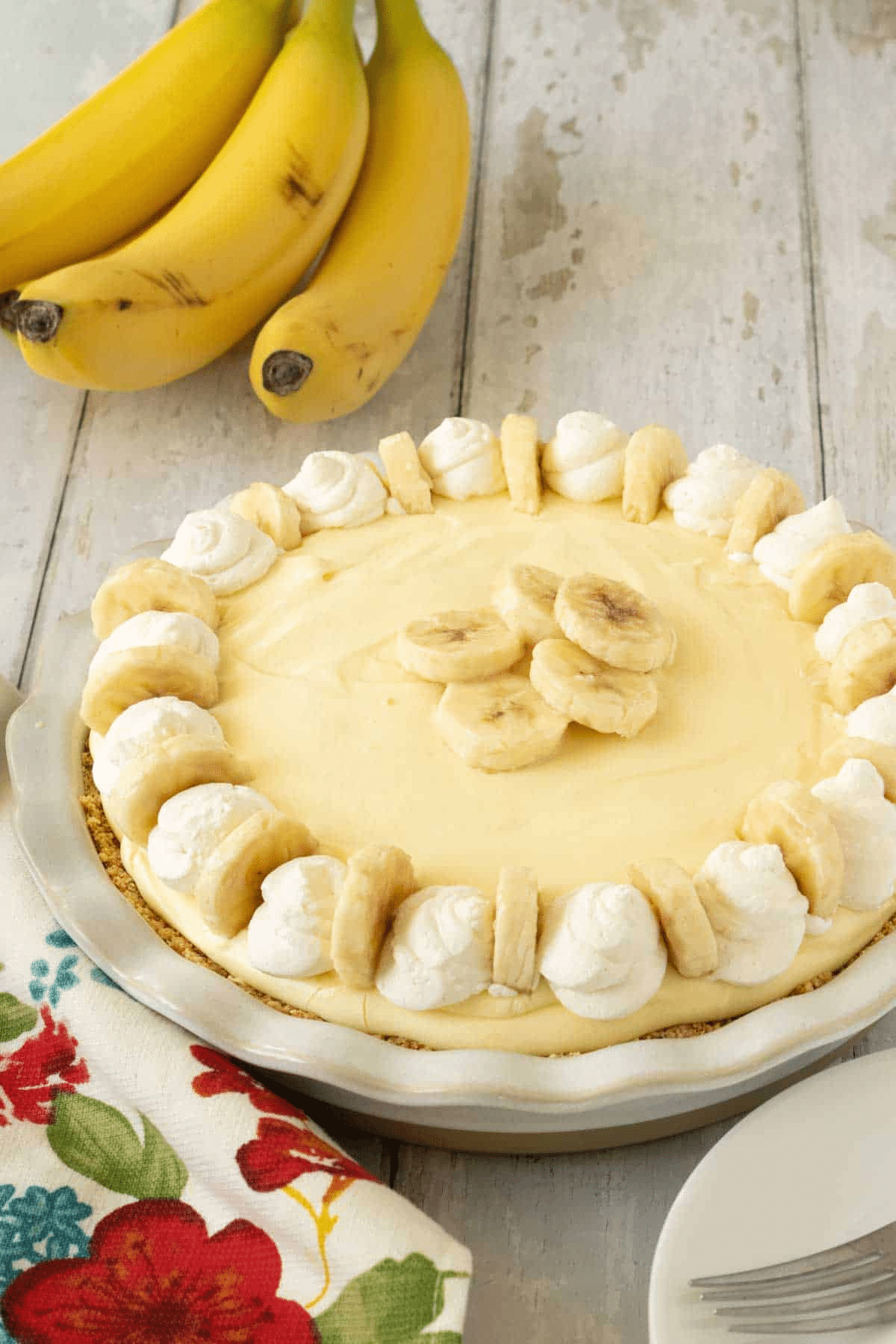 Banana Cream Pie in a pan with sliced bananas on top. 