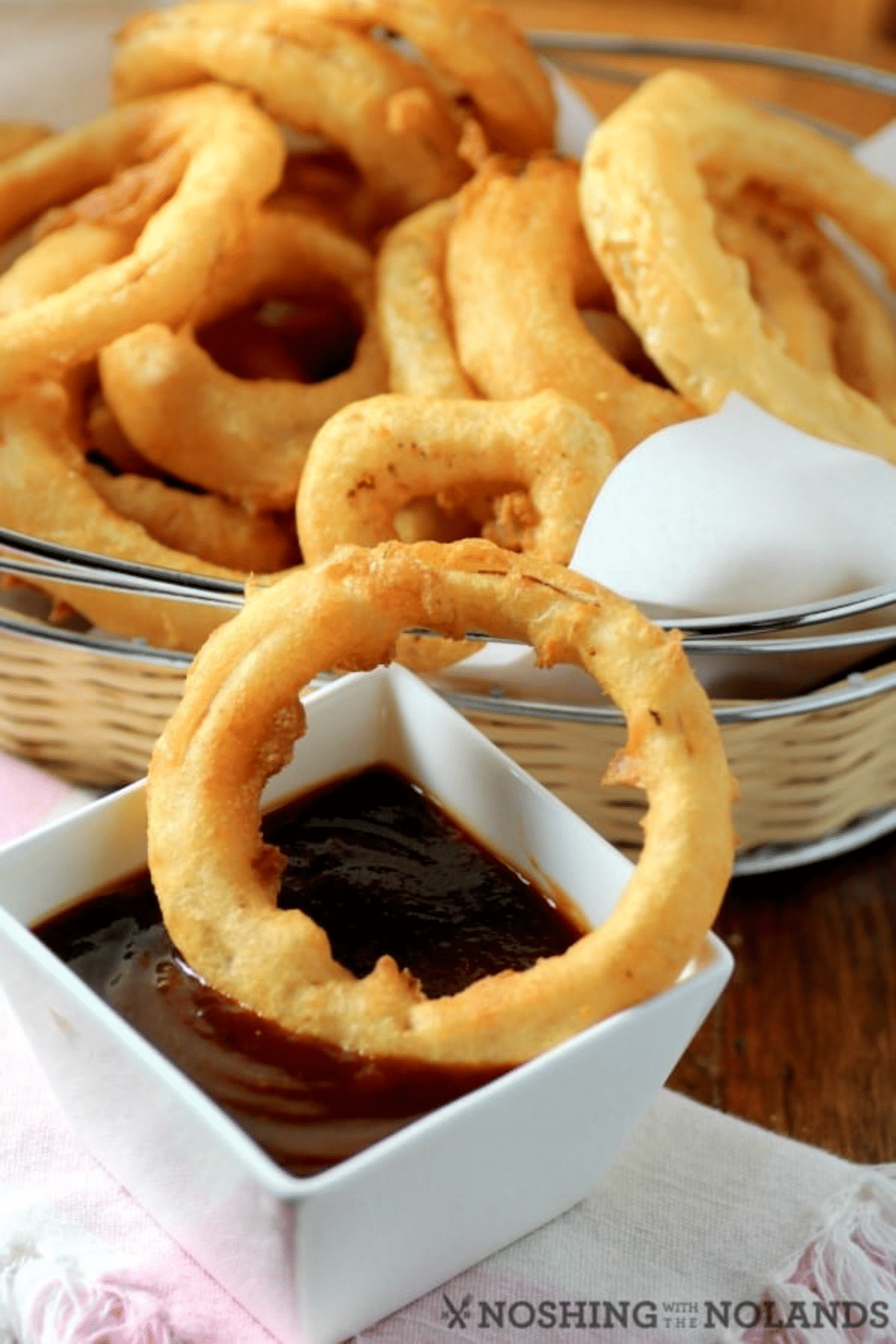 Dipping onion rings into BBQ sauce. 