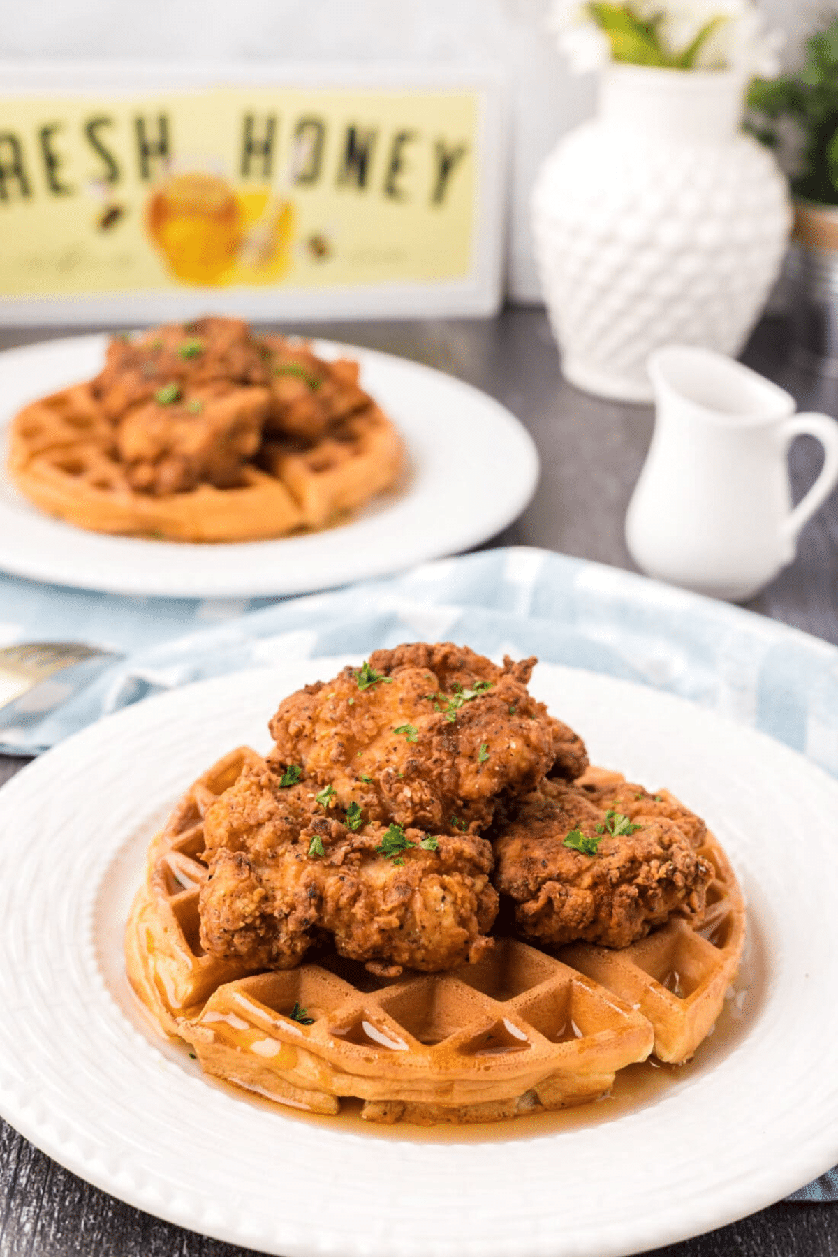 Fried chicken and waffles on a white plate. 