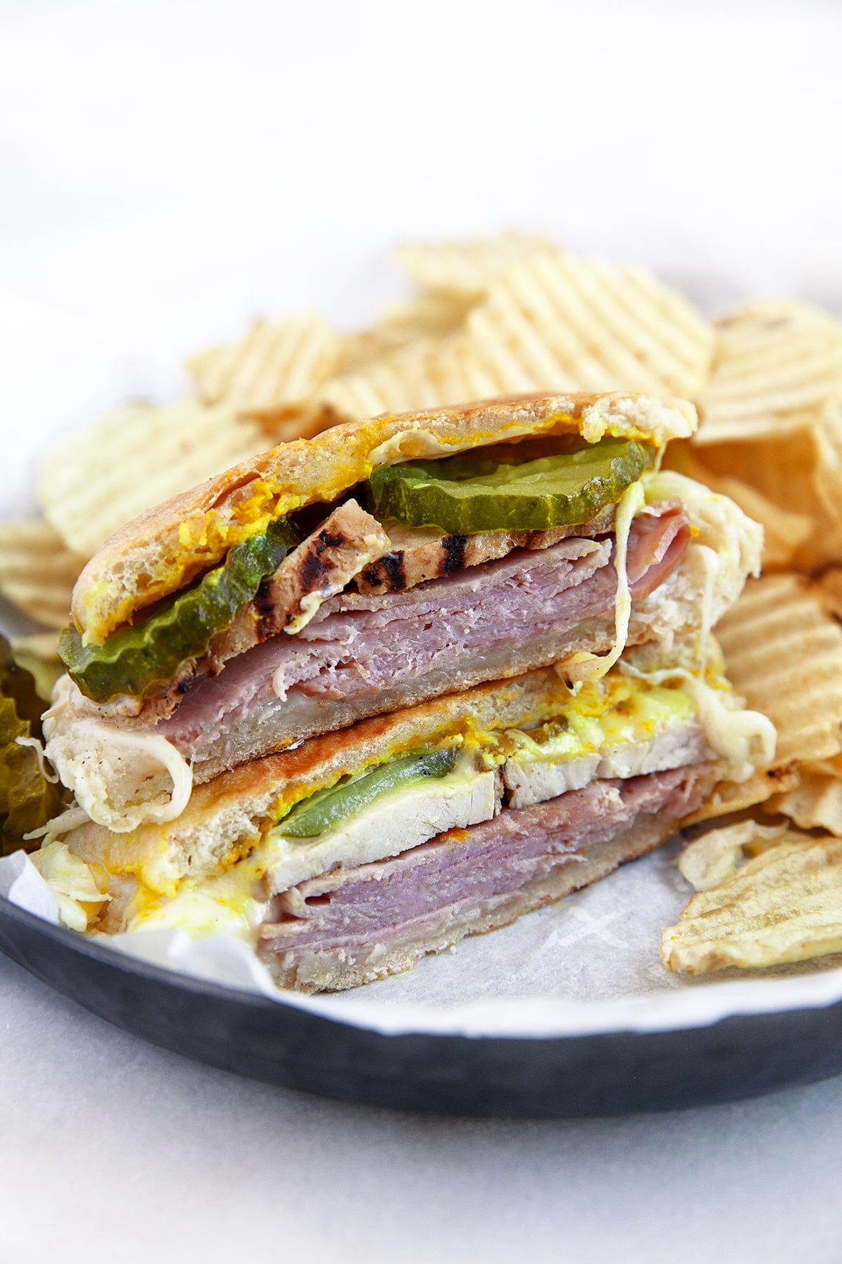 Cubano sandwich cut in half and stacked with ripple chips. 