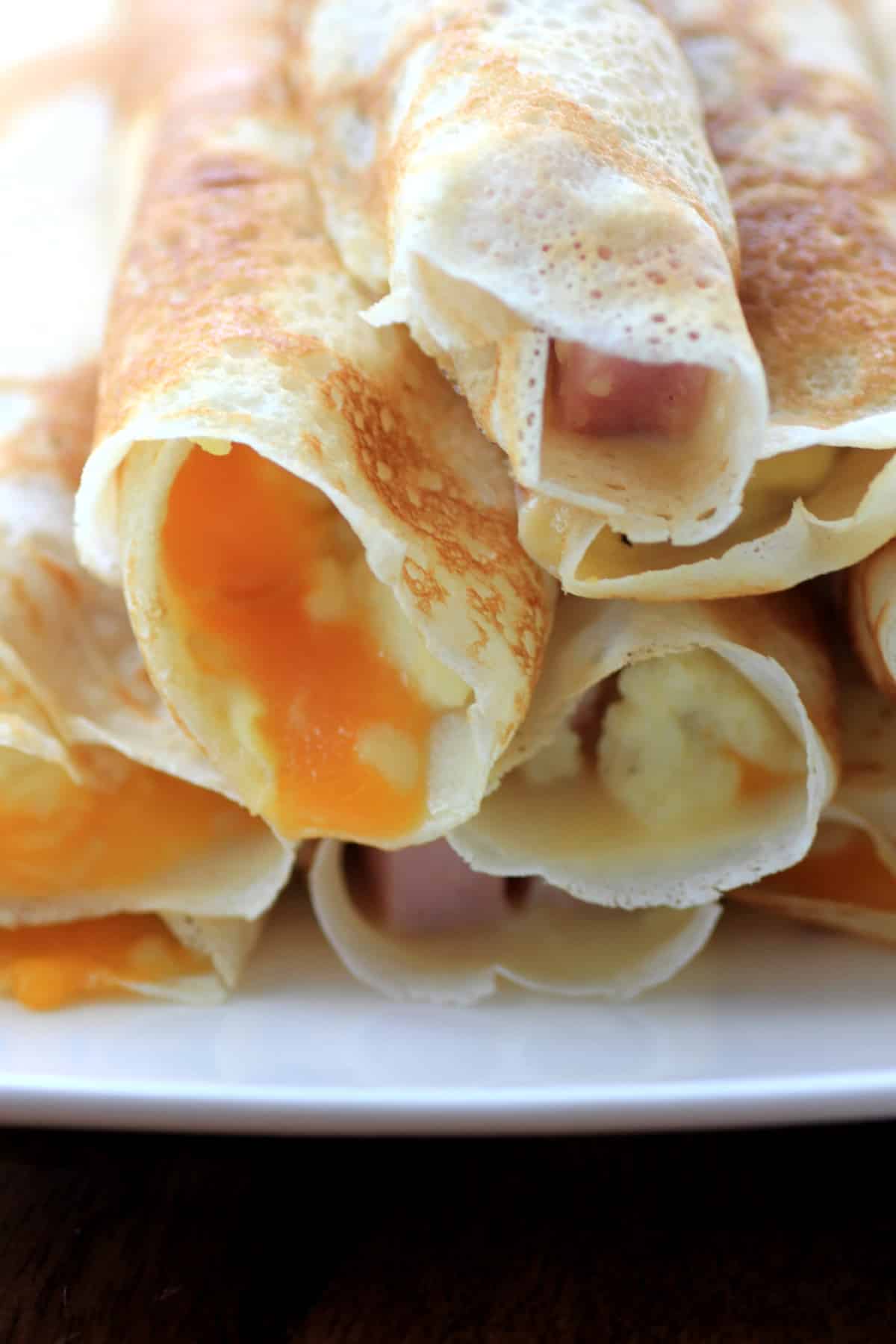 Egg, Ham, and Cheese Stuffed Crepes close-up. 