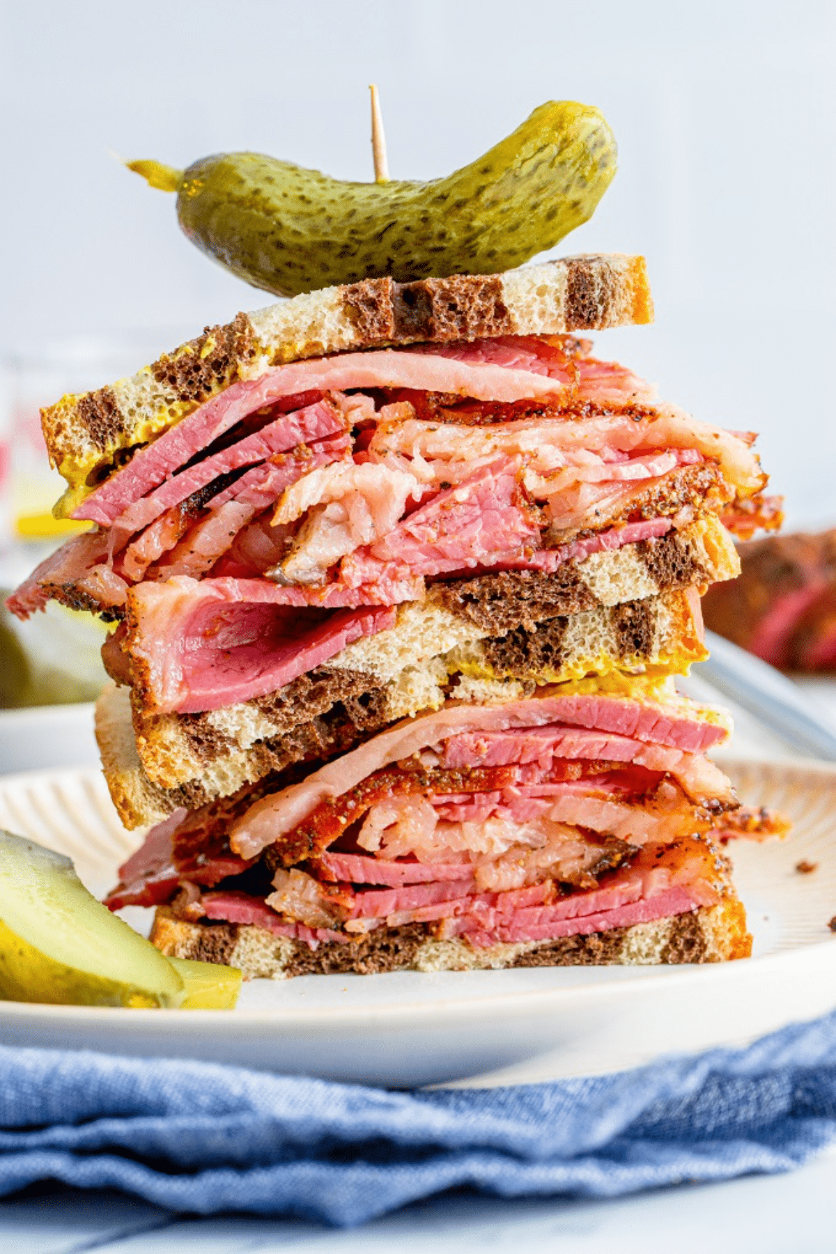 Loaded smoked pastrami sandwich on multi-colored rye bread. 