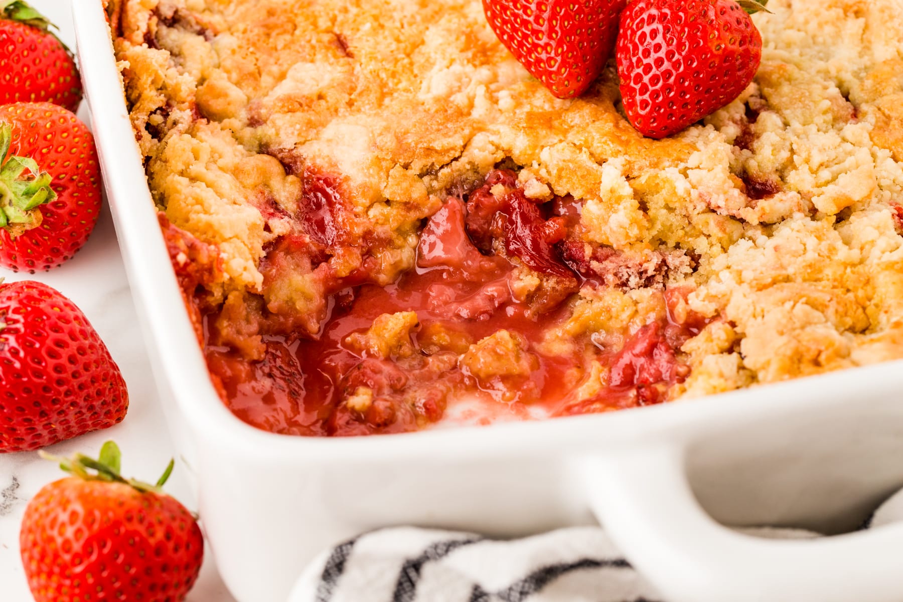 Horizontal picture of strawberry dump cake showing the inside with luscious juicy strawberries. 