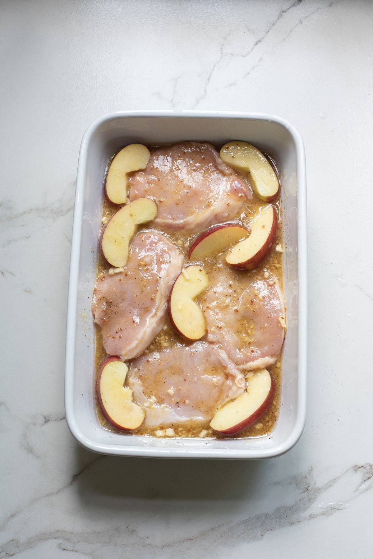Apples and pork chops ready for the oven. 