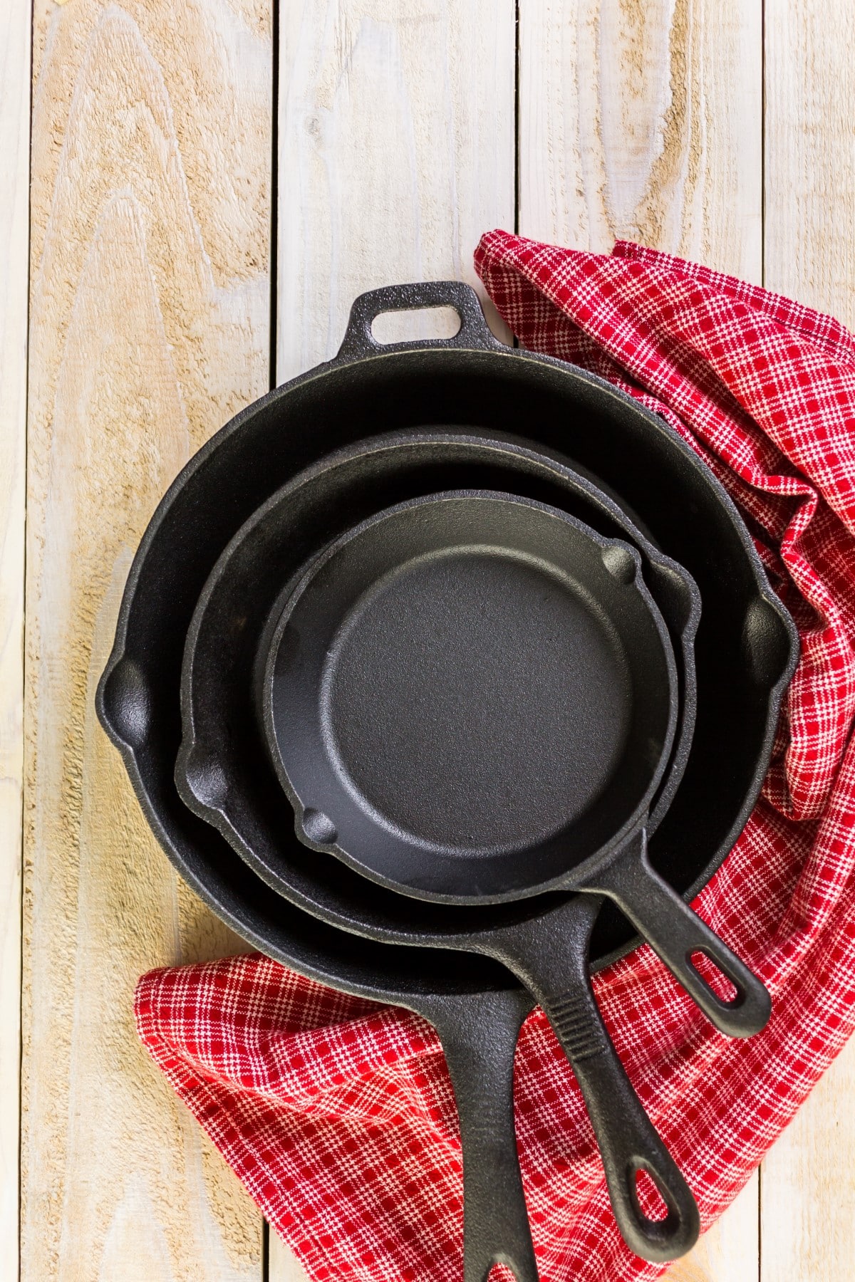 Cast iron skillet on rustic wood table.