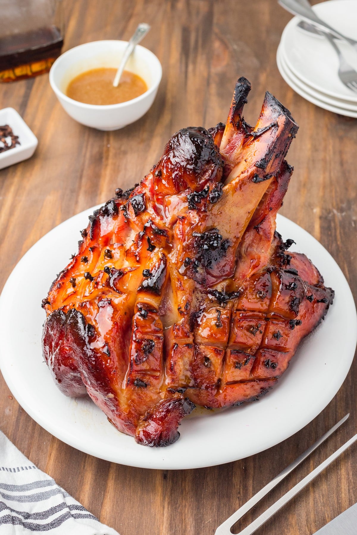 Glazed bone-in ham on a plate. 